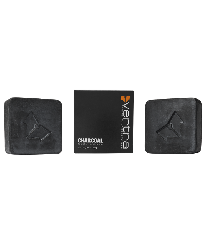 Charcoal Cleansing Bar x Brisa Hennessy | Vertra featuring two black charcoal soap bars with embossed logos and a black box with white and orange branding, ideal for skincare and body care.
