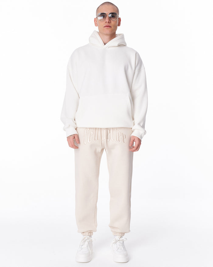 Martin Valen "Fell Better" men's beige jogger, front mid-body view showing embroidered waistband