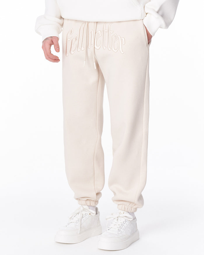 Martin Valen "Fell Better" men's beige jogger, close-up showing large 'fell better' embroidery across the front