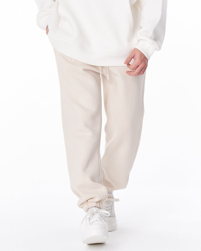 Martin Valen "Fell Better" men's beige jogger, mid-body view showing drawstring and hand near the pocket