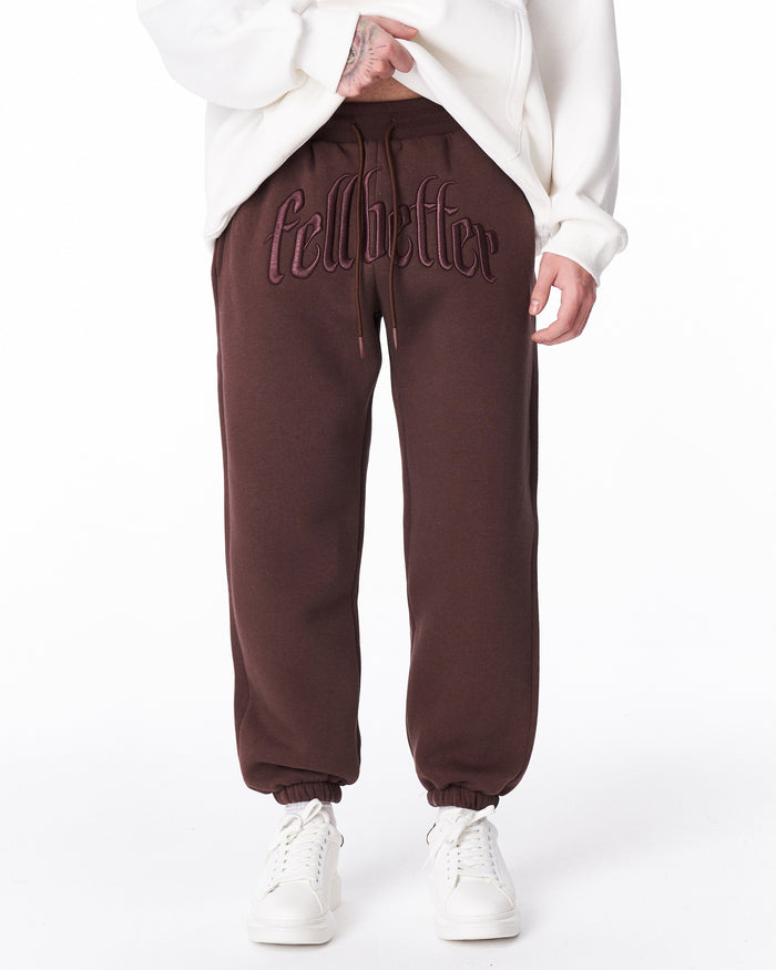 Martin Valen brown "Fell Better" men's jogger, front close-up showing embroidered logo on the waistband