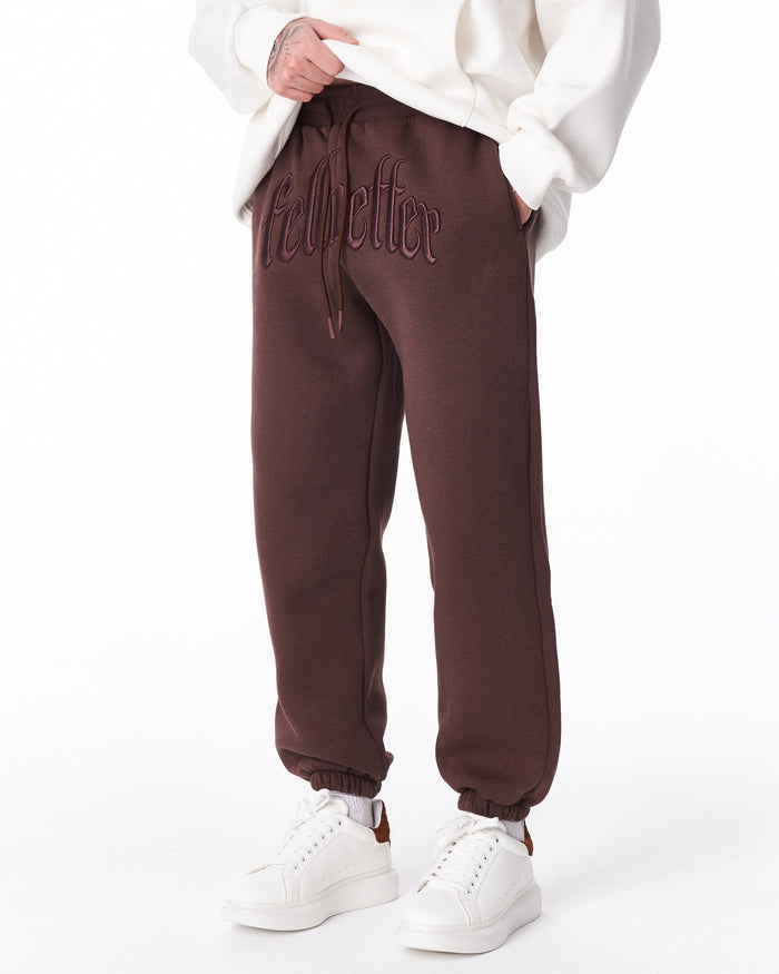Martin Valen brown "Fell Better" men's jogger, mid-body view showing drawstring and embroidered lettering