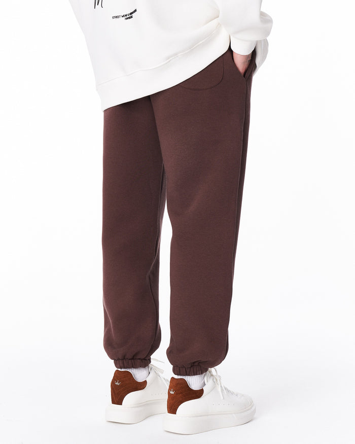 Martin Valen brown "Fell Better" men's jogger, knee-to-shin view showing side pocket and elastic cuffs