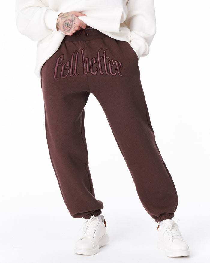 Martin Valen “Fell Better” men's brown embroidered jogger, close-up waist view showing front embroidery
